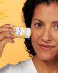 A person applying the Satya Eczema Relief Easy Glide Stick to their face.