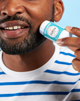 A person applying the Satya Multi Use Easy Glide Stick to their beard.
